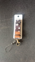Close-up of floral print fabric neck lanyard with leather patch