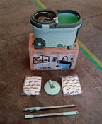 All components of the Ganesh Quick Spin Mop, including the bucket, handle, and two mop heads.