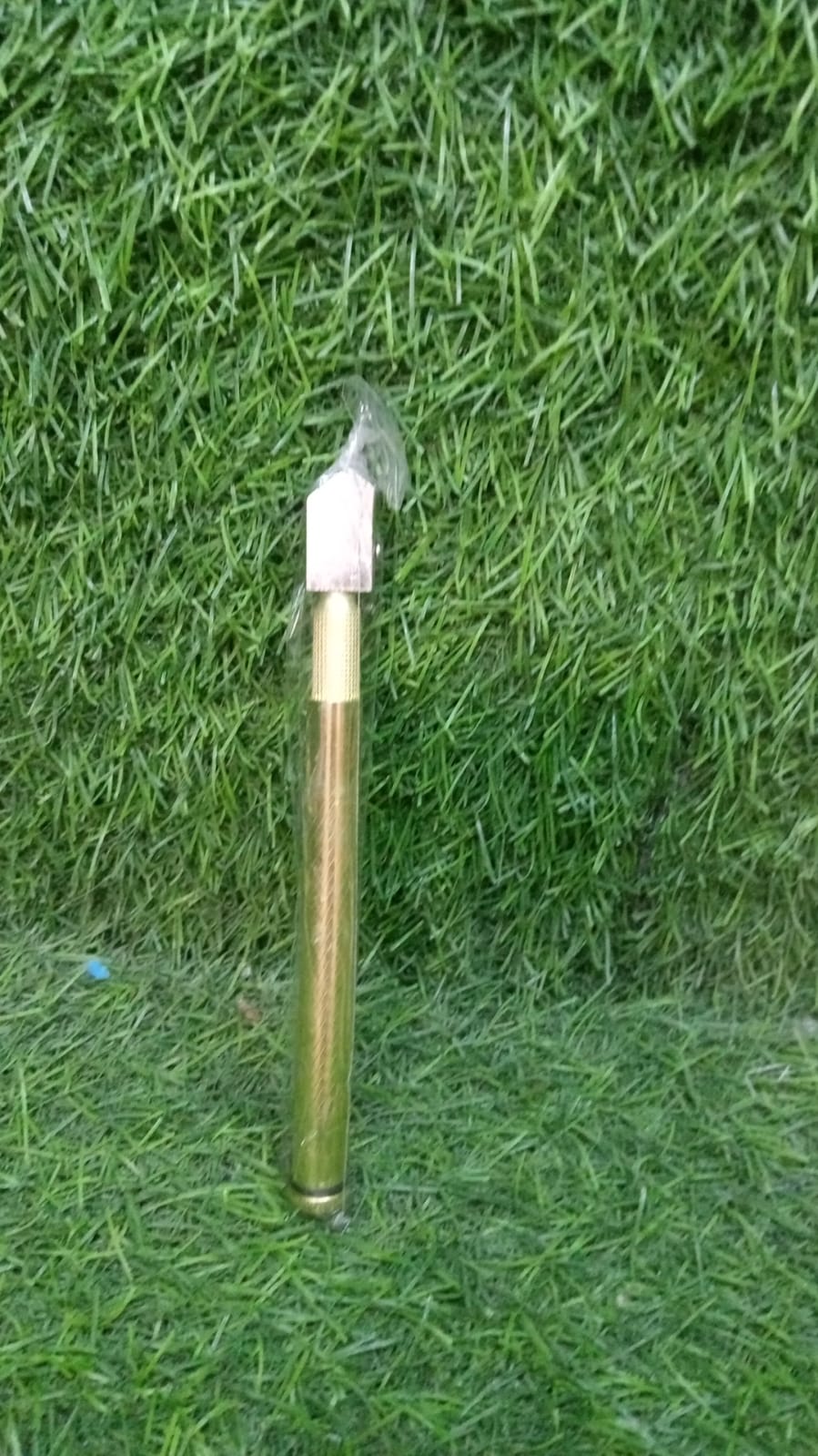 Detailed view of the high-quality gold glass cutter's cutting head.