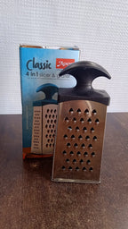 Close-up of stainless steel blades on 4-in-1 kitchen grater and slicer
