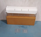 A wall mount drawer organizer shown with its adhesive backing for easy, drill-free setup.