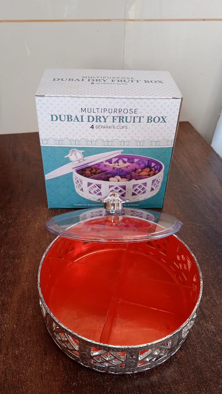 Round silver dry fruit box displayed for home serving on a table.