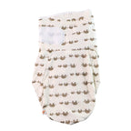 Baby sleeping comfortably in soft cotton swaddle wrap