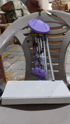 Detailed view of the top hanging ring and bamboo structure of the wind chime.