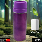 Sleek stainless steel sipper bottle on a wooden surface, ready for use.