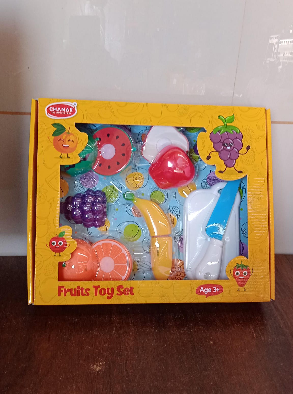 All seven pieces of the Aditi sliceable fruit cutting toy set neatly arranged.