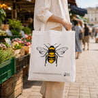 Woman carrying bee print tote bag at market
