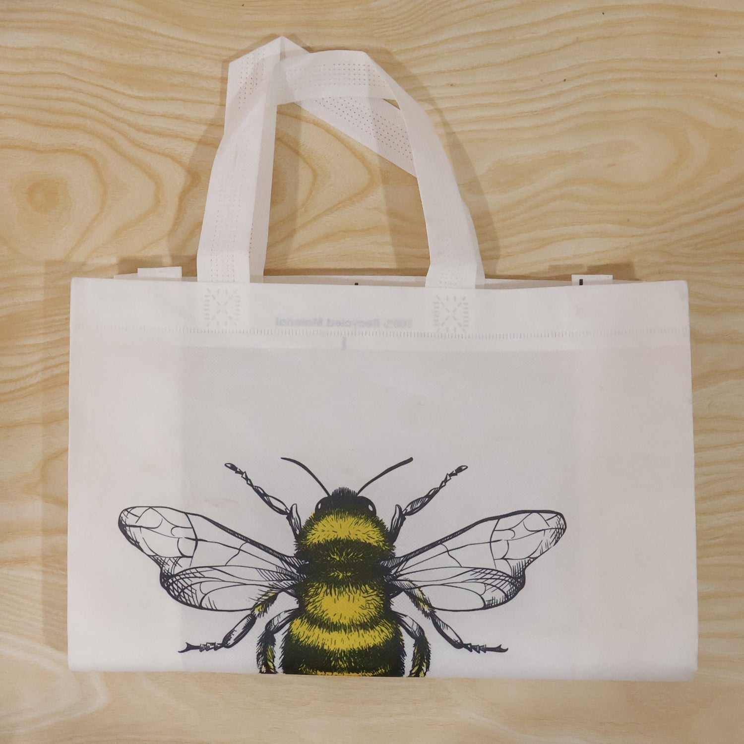 Top view of bee print tote bag showing material and design