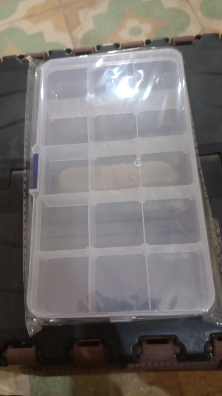 Open clear jewellery organizer box with adjustable dividers, demonstrating its spacious and flexible design.