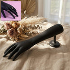 Black hand jewelry display stand with matte finish showing front view