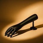 Side view of black hand-shaped jewelry display stand