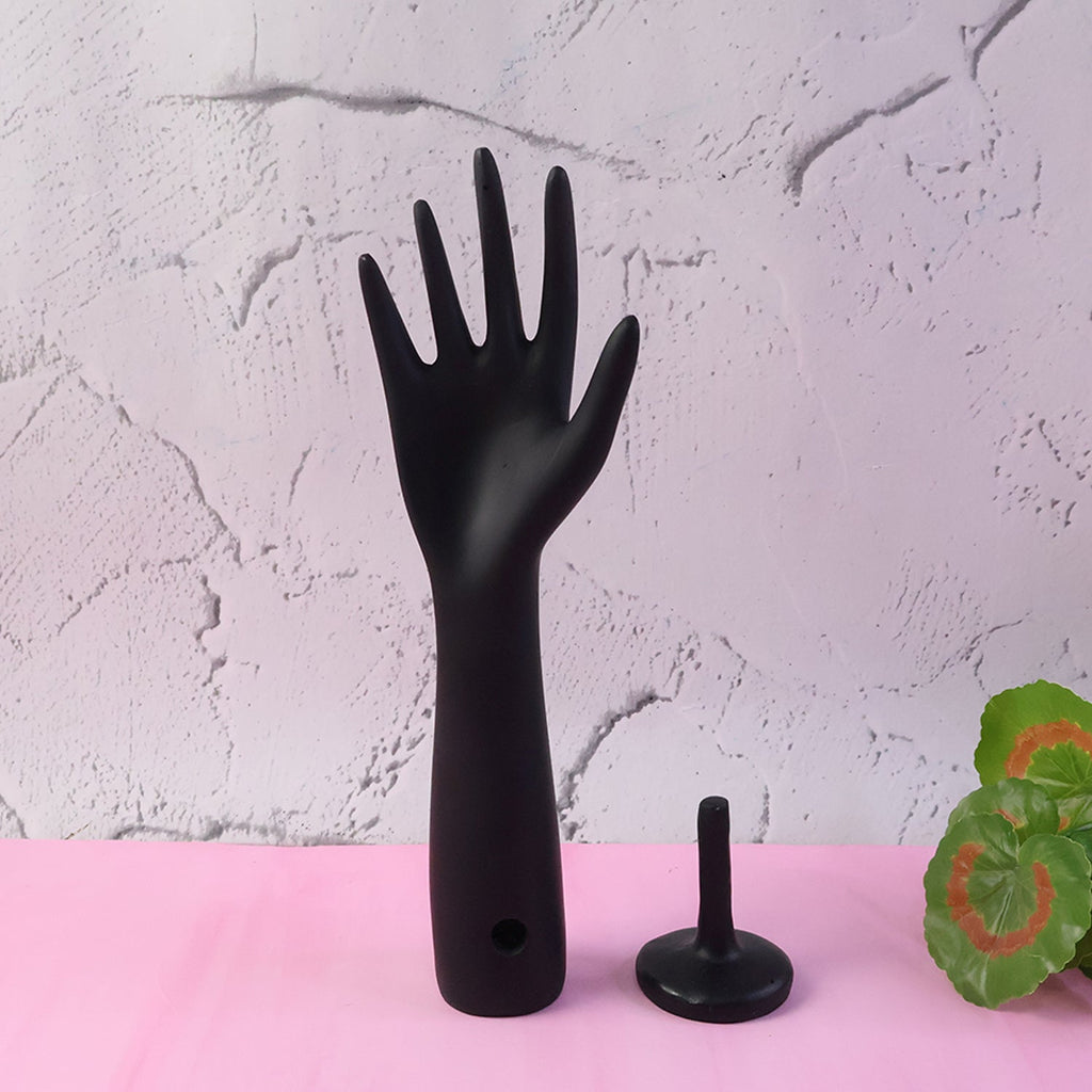Close-up elegant matte black hand jewelry stand surface texture