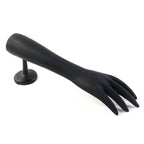 Jewelry pieces displayed elegantly on black hand-shaped stand