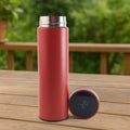Red vacuum insulated water bottle with LED temperature display on top.