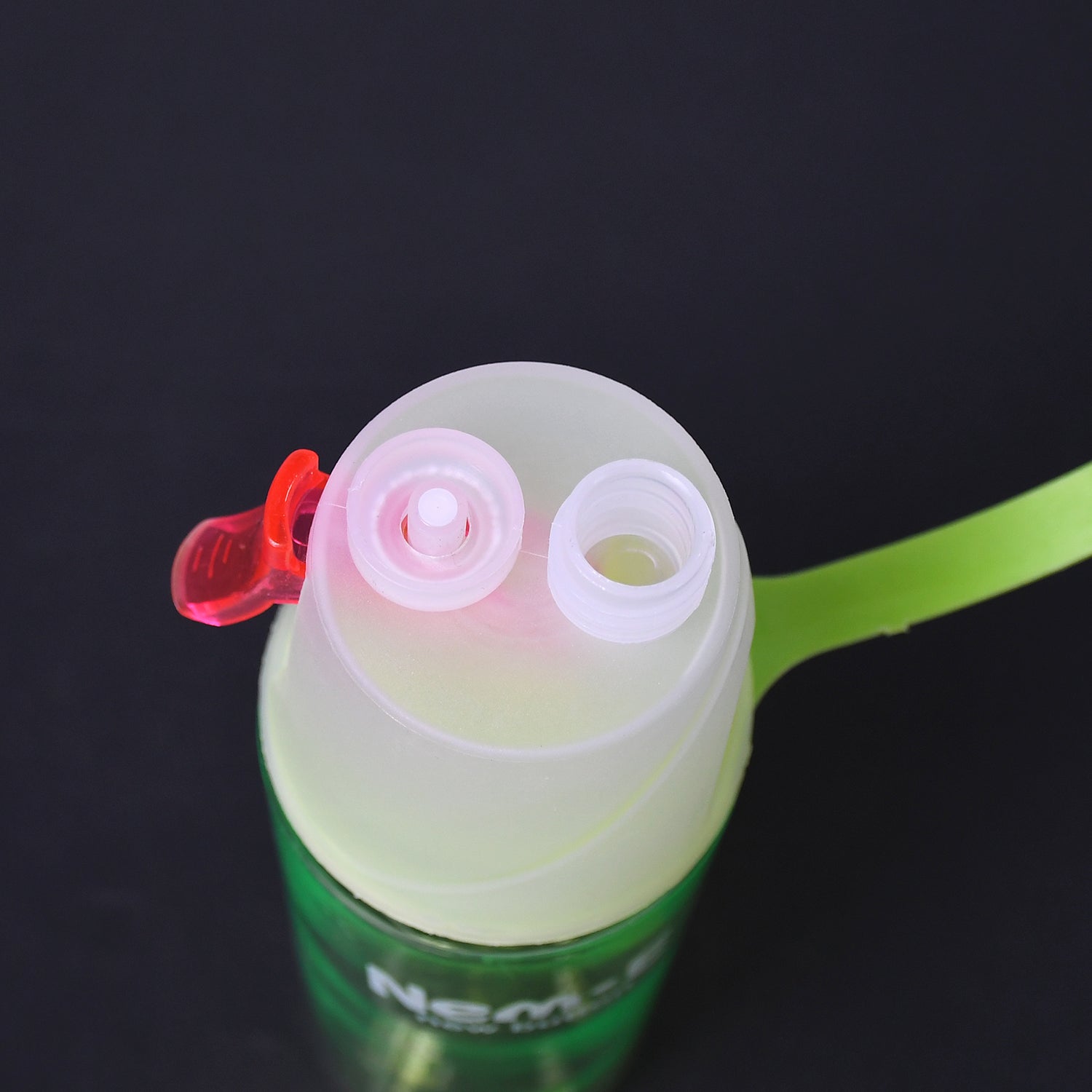 A durable sports spray water bottle used on a hiking trail, providing hydration and cooling mist.