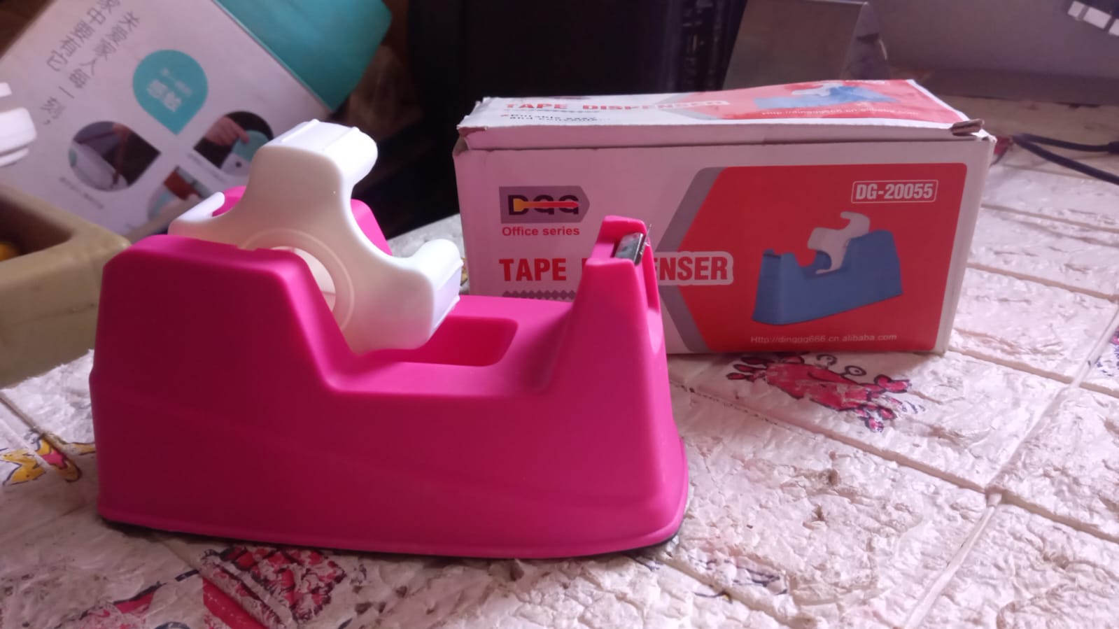 Tape dispenser with a roll of brown packaging tape, ready for shipping.