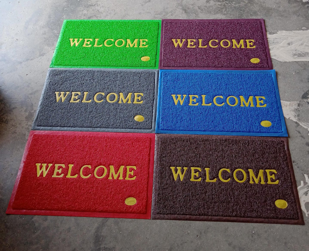 An overhead shot of the Welcome Door Mat in a clean, minimalist home setting.