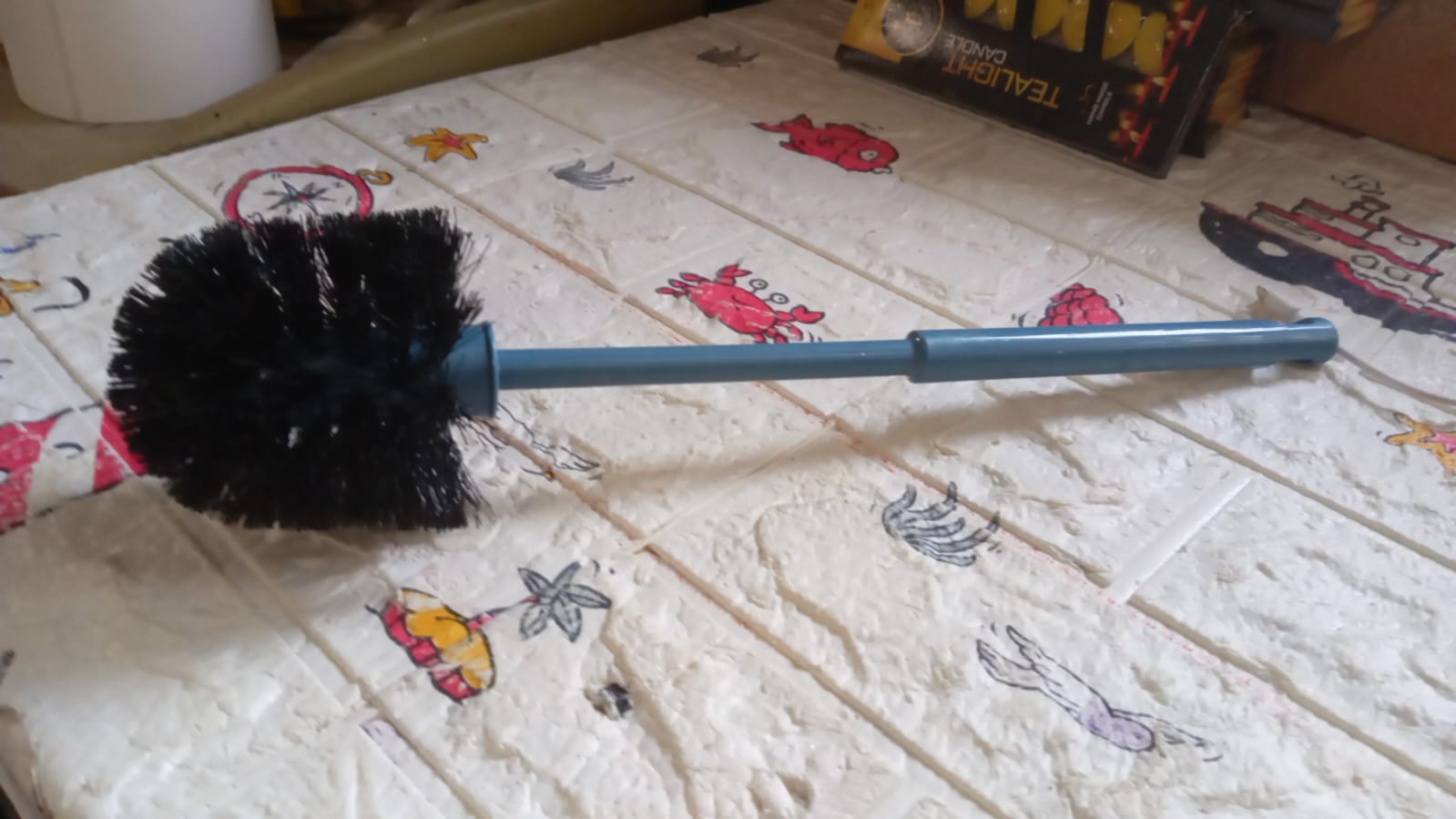 Plastic toilet cleaning brush with a strong handle for tough stains.