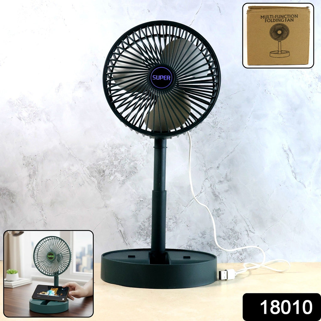 Foldable USB desk fan placed next to a phone on office table
