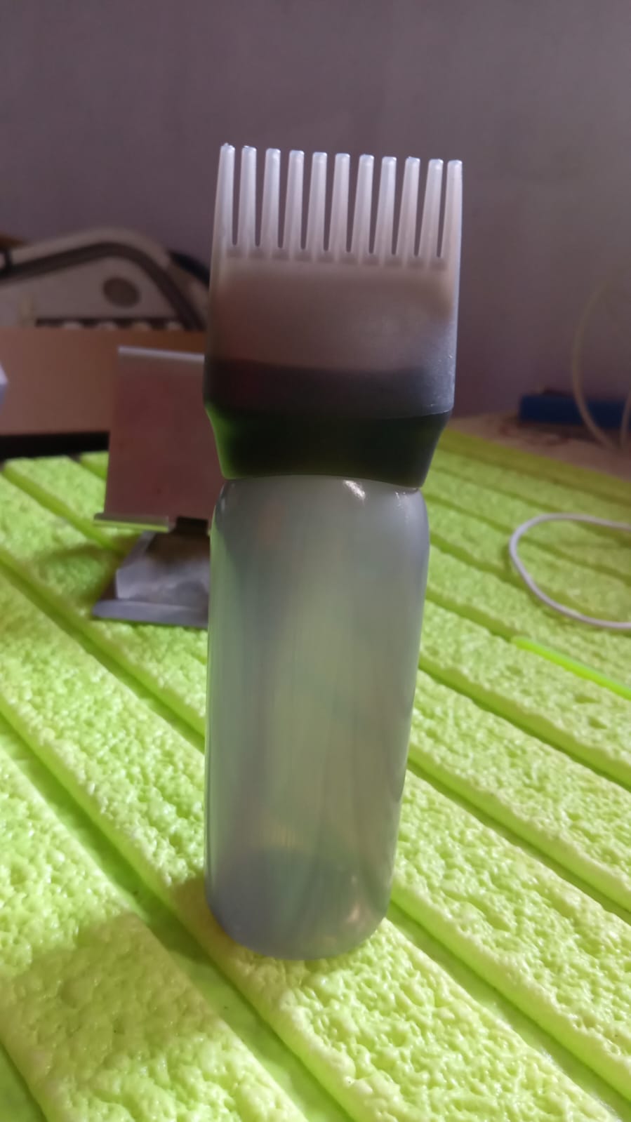 Front view of the professional hair comb applicator bottle, ready for use.
