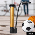 Compact metal hand air pump inflating a basketball on a court.
