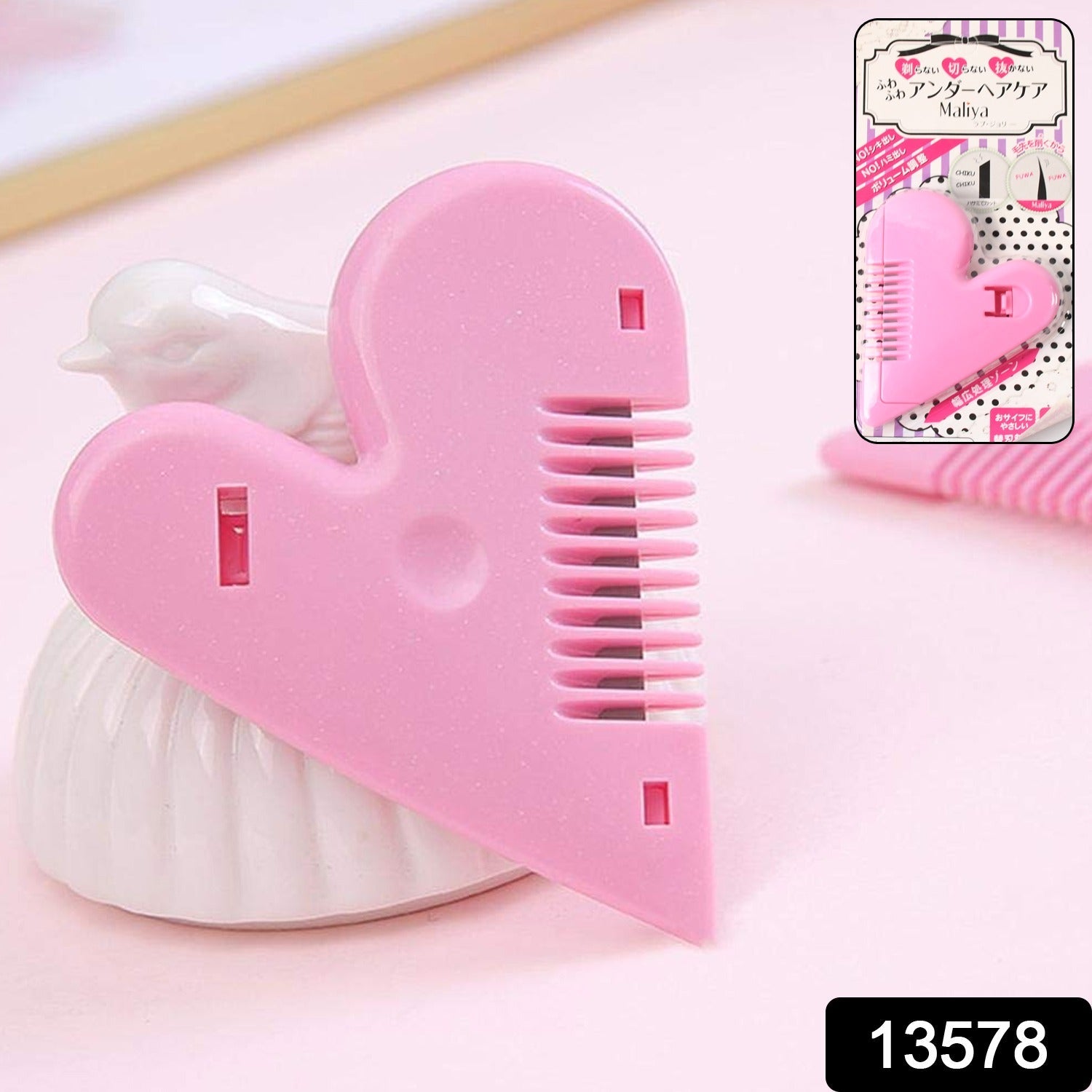 Pair of heart-handled hair scissors on white background