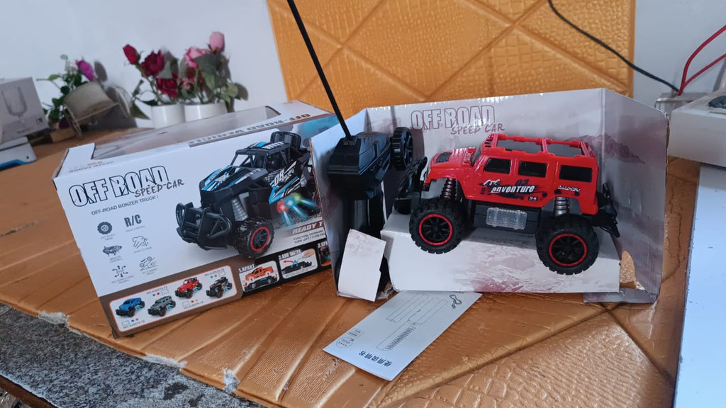 Mist Spray Race Car Toy navigating an off-road rocky surface, emitting smoke.