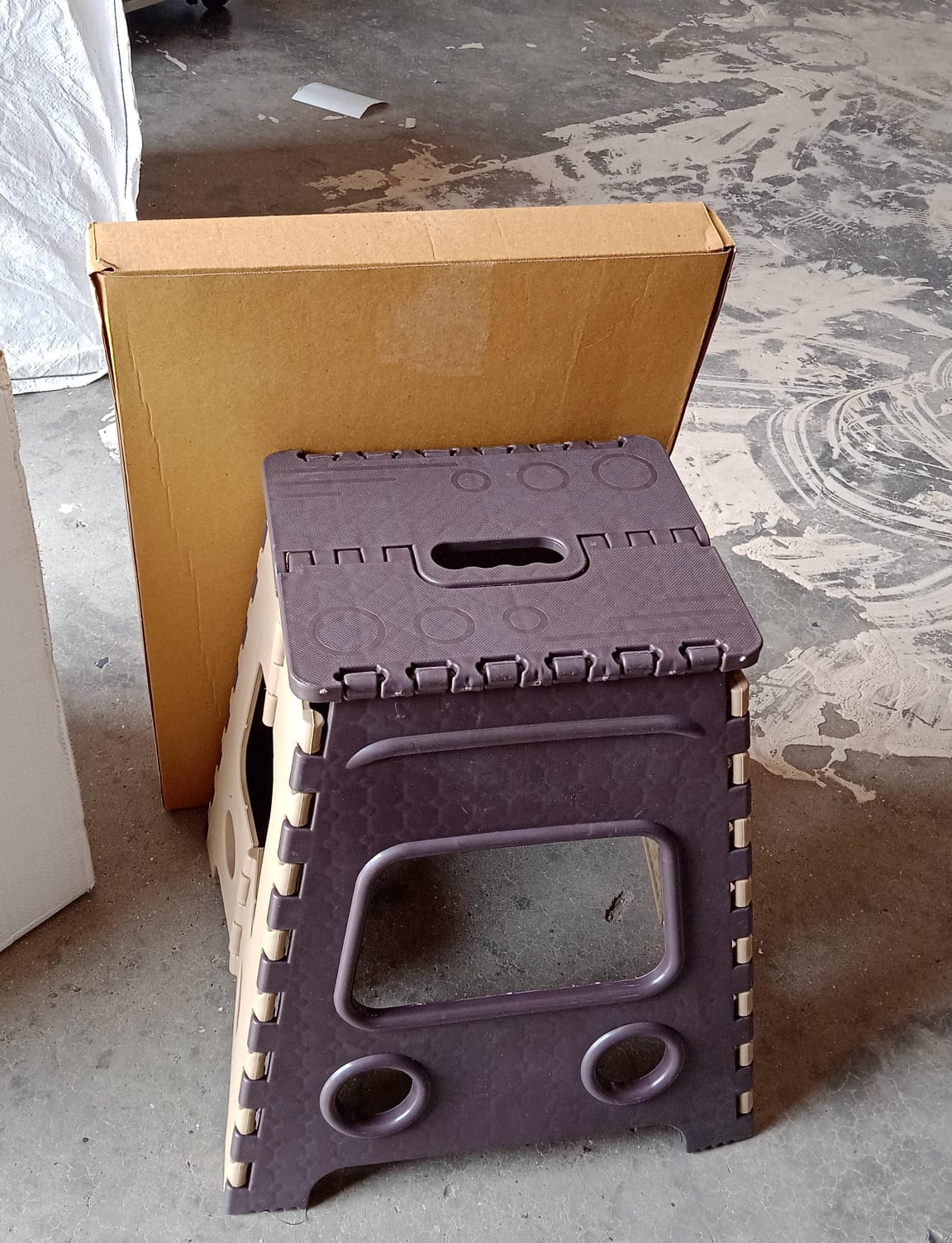 Folded 18 Inch Folding Stool, demonstrating its ultra-compact storage capability.