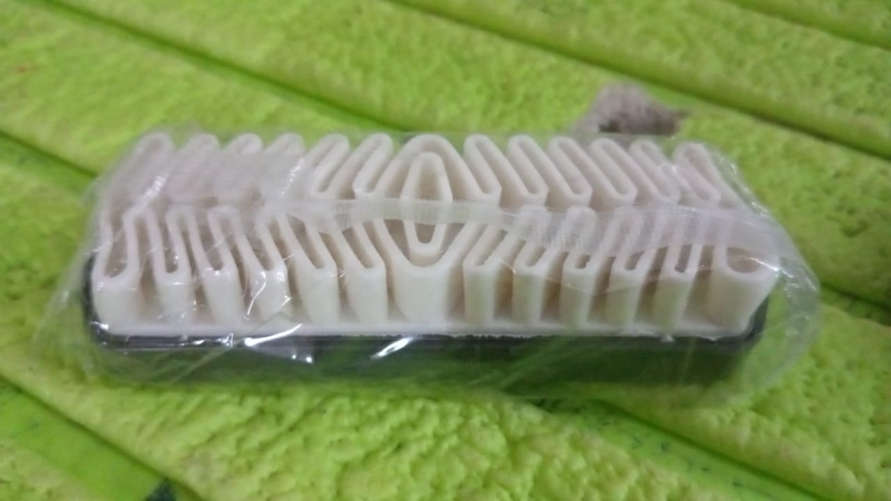 Shoe cleaning brush being used on leather footwear