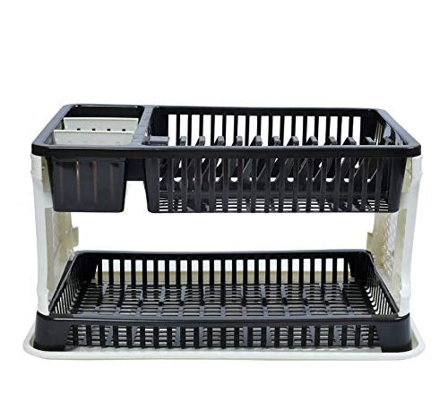 Black plastic dish drying rack with water collection tray on a kitchen counter.