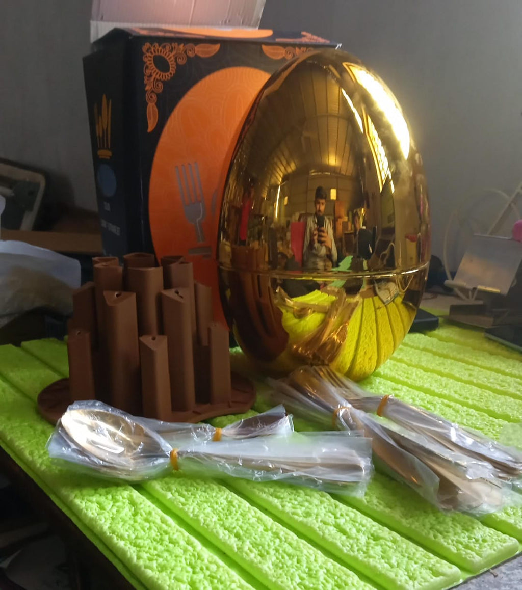 Golden knives meticulously stored in the modern oval cutlery stand.