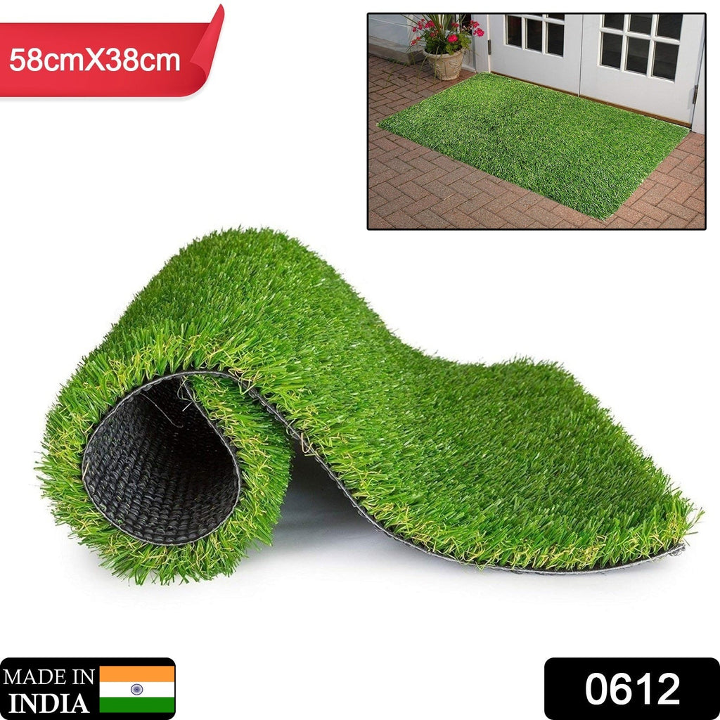 The durable plastic grass mat laid out, showcasing its vibrant green colour for a balcony.