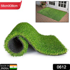 The durable plastic grass mat laid out, showcasing its vibrant green colour for a balcony.