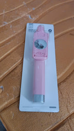 Pastel pink selfie stick with wired shutter button and rearview mirror visible