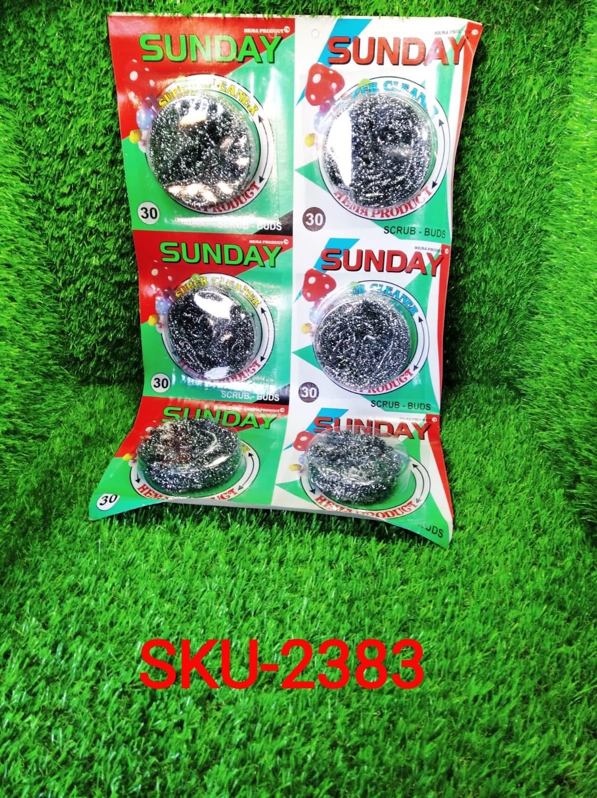 An individual round stainless steel scrubber, highlighting its textured surface for better grip.