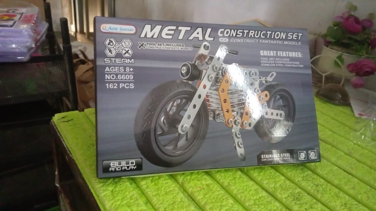 Kids enjoying the challenge of assembling the metal bike building blocks.