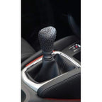 Protective gear shift knob cover in a car, showing its snug fit.