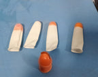 A collection of colorful finger covers, likely used as protectors with cutting tools.