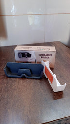 Organivo Sunglass Wall Organizer securely mounted on a textured wall, offering convenient eyewear storage.