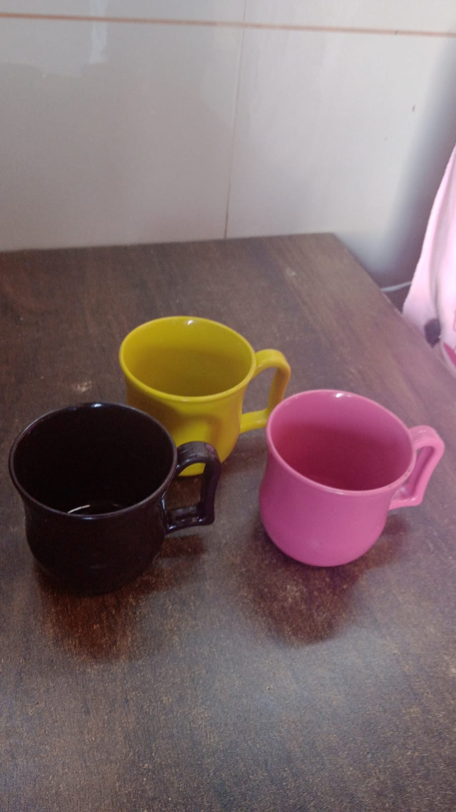 An empty plastic coffee mug ready for use, showcasing its sturdy base and comfortable grip.