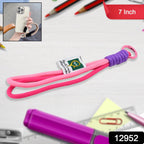 Person holding a mobile phone secured with a vibrant multi-color hand wrist strap.