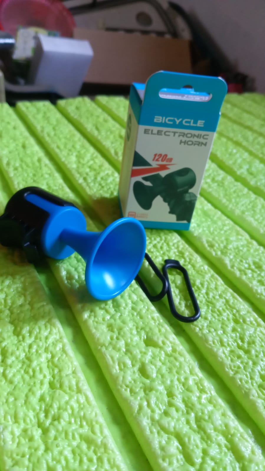 The electric bicycle horn presented in its protective retail packaging.