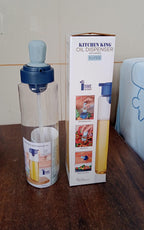 Elegant oil dispenser bottle standing upright on a kitchen counter, blending with modern decor.