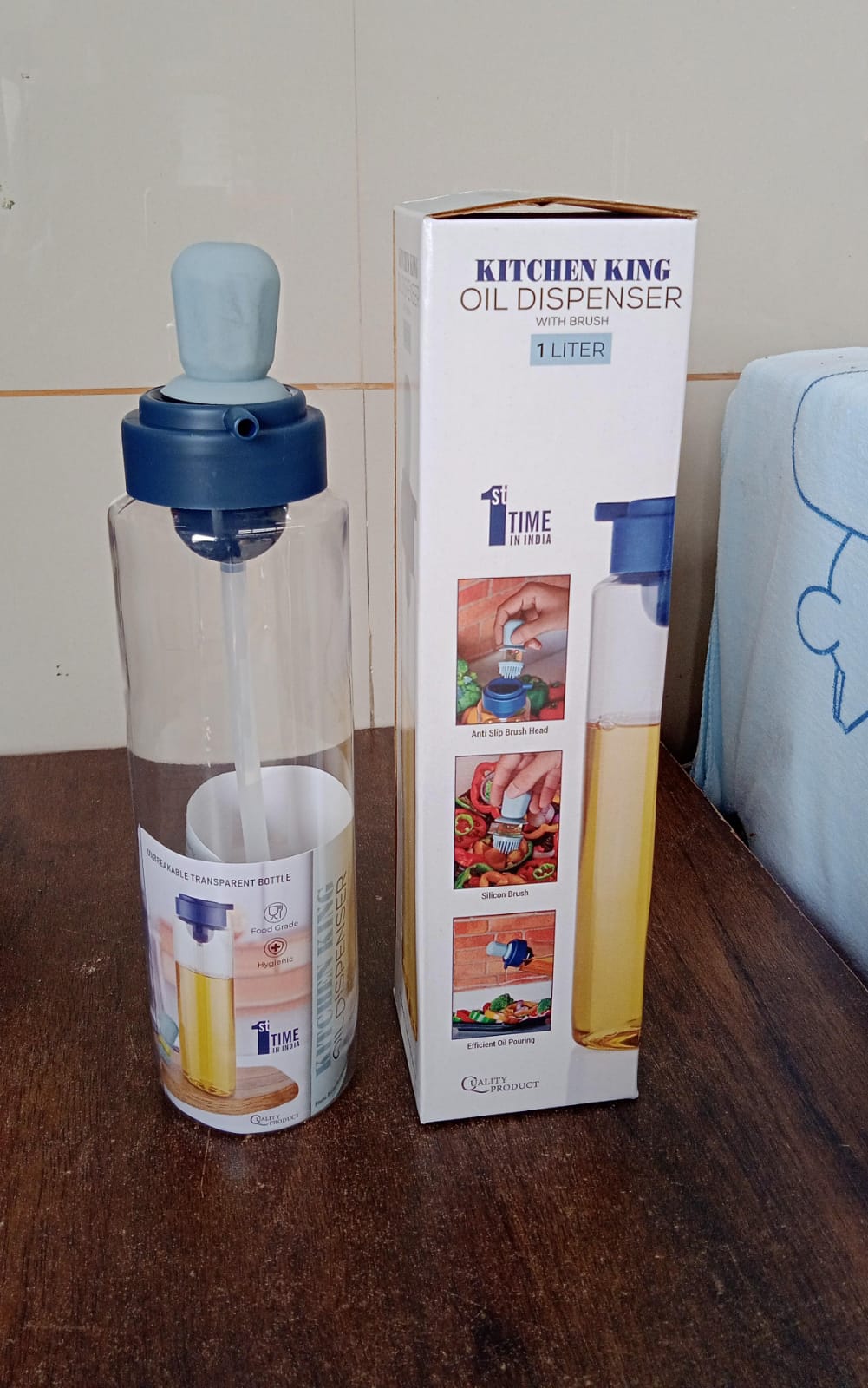 Elegant oil dispenser bottle standing upright on a kitchen counter, blending with modern decor.