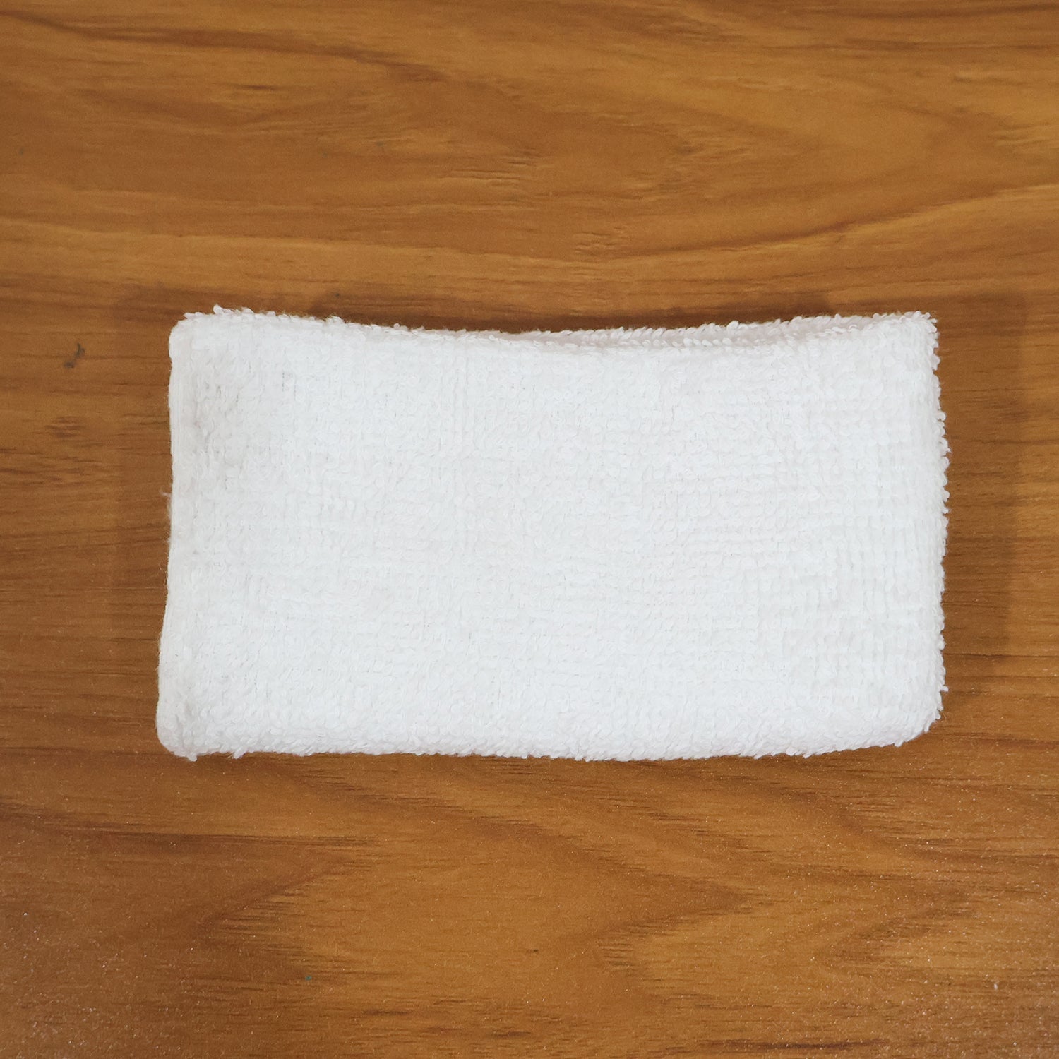 Person cleaning wooden furniture surface with microfiber cloth