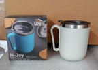 The Ganesh brand logo prominently displayed on the premium stainless steel coffee mug.