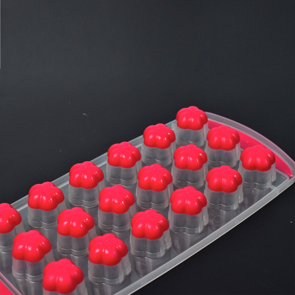 The silicone flower ice tray next to a glass of drink with creative floral ice.