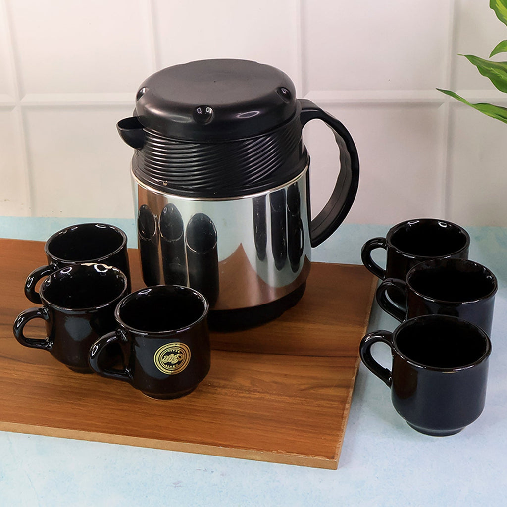 Thermos flask with handle alongside six ceramic cups for hot beverage servings