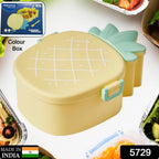 Close-up textured view of the bright yellow pineapple lunchbox lid.