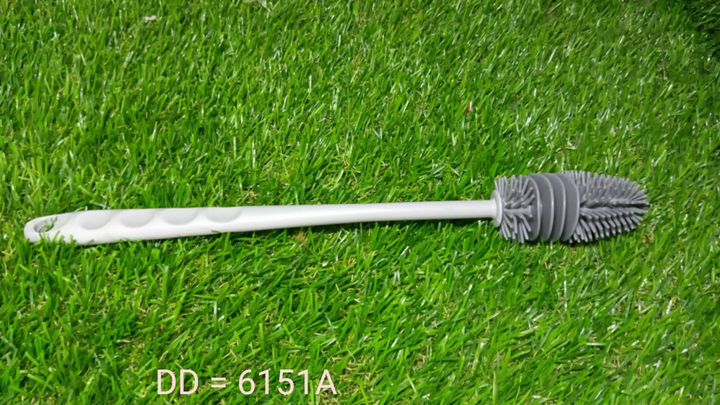 A bottle cleaning brush shown cleaning a narrow-necked bottle with ease.